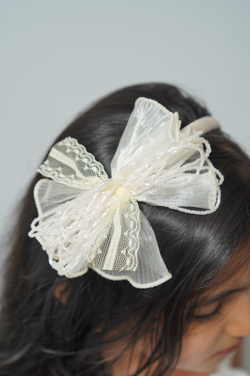Mesh flower with beaded bows